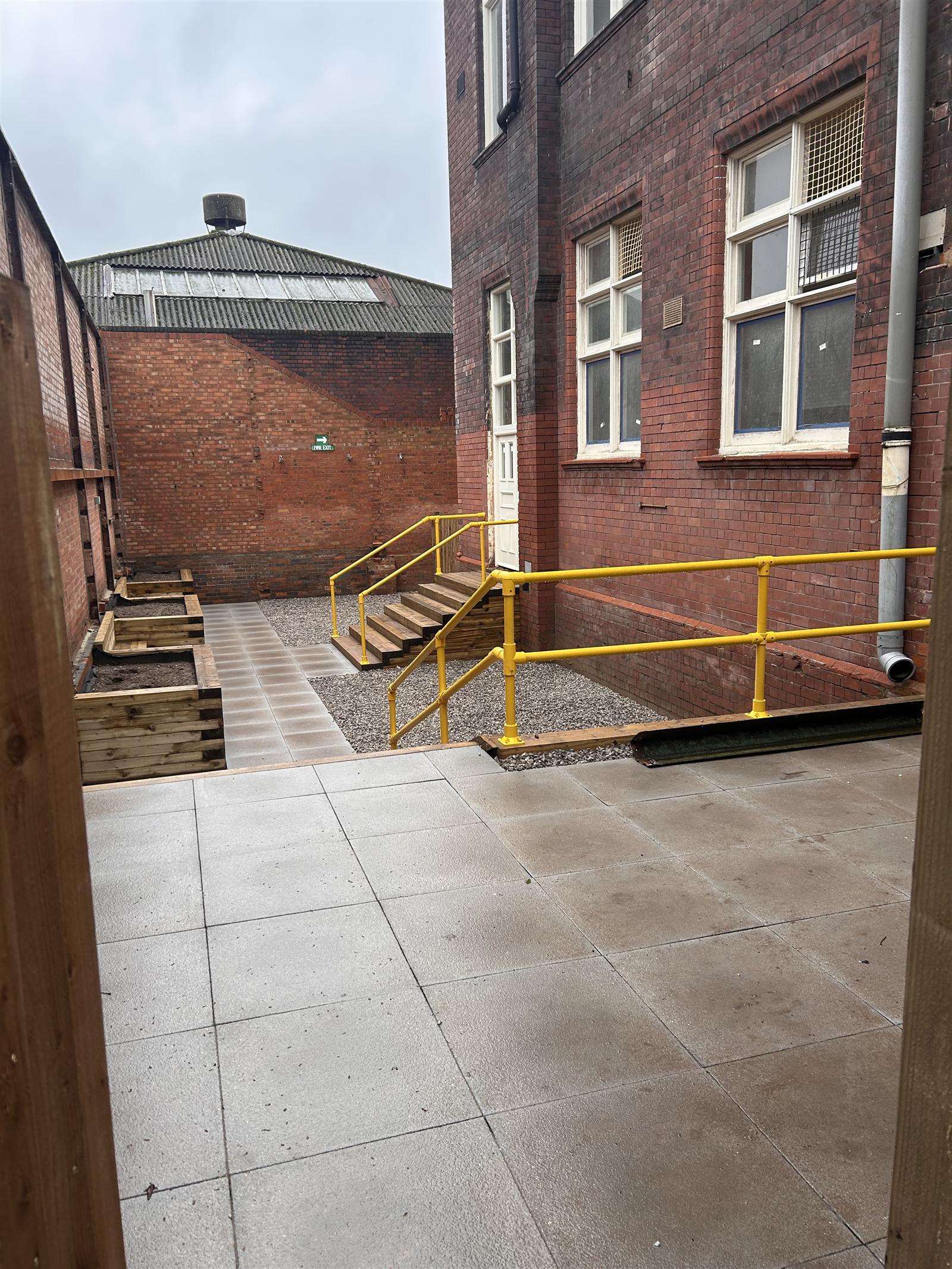 The courtyard garden with raised planters and accessible ramps